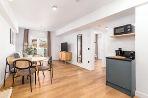 One-Bedroom Comfort Apartment + Balcony | Living area | 50-inch flat-screen TV with cable channels