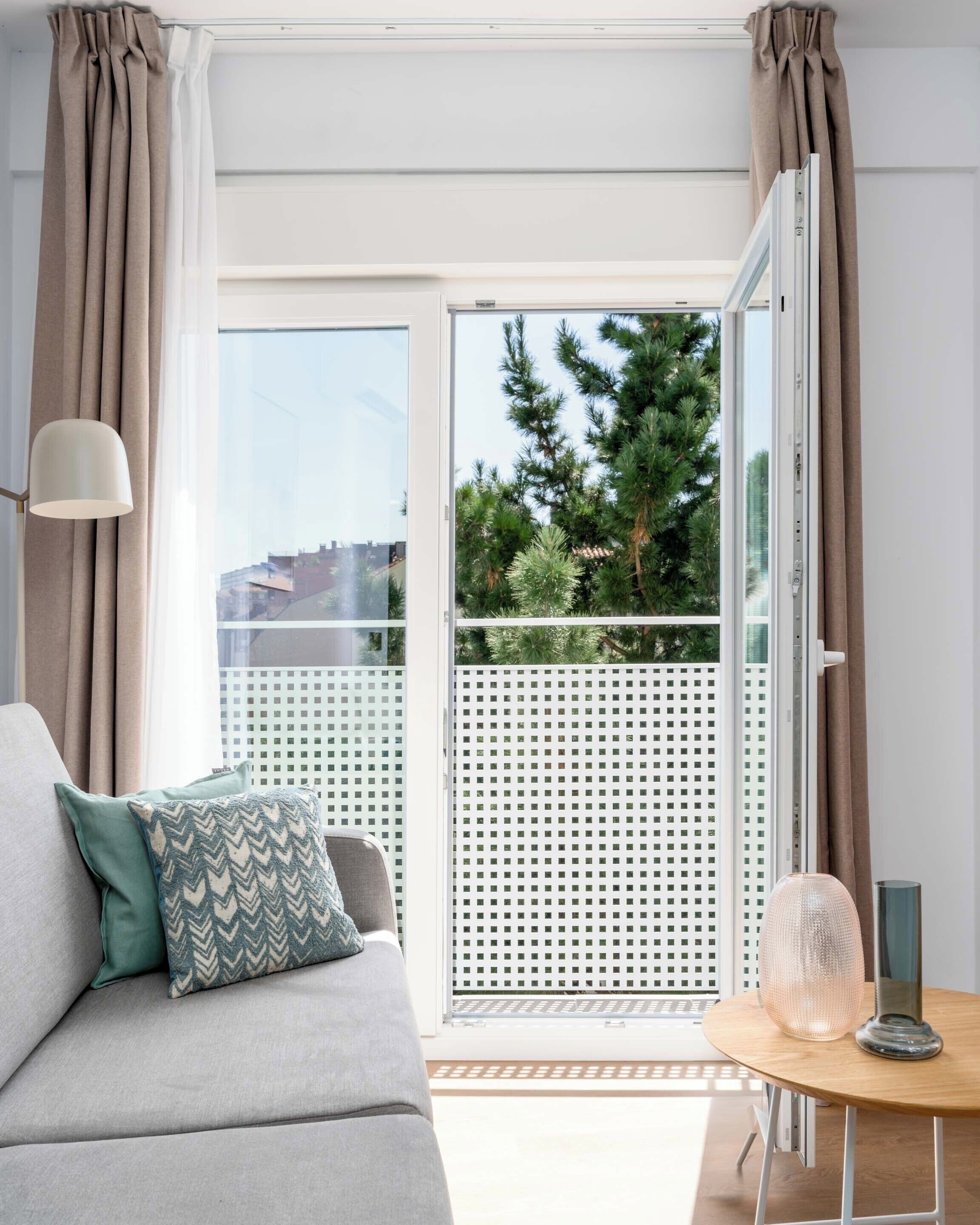 One-Bedroom Junior Apartment + Balcony | Living area | 50-inch flat-screen TV with cable channels