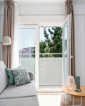 One-Bedroom Junior Apartment + Balcony | Living area | 50-inch flat-screen TV with cable channels