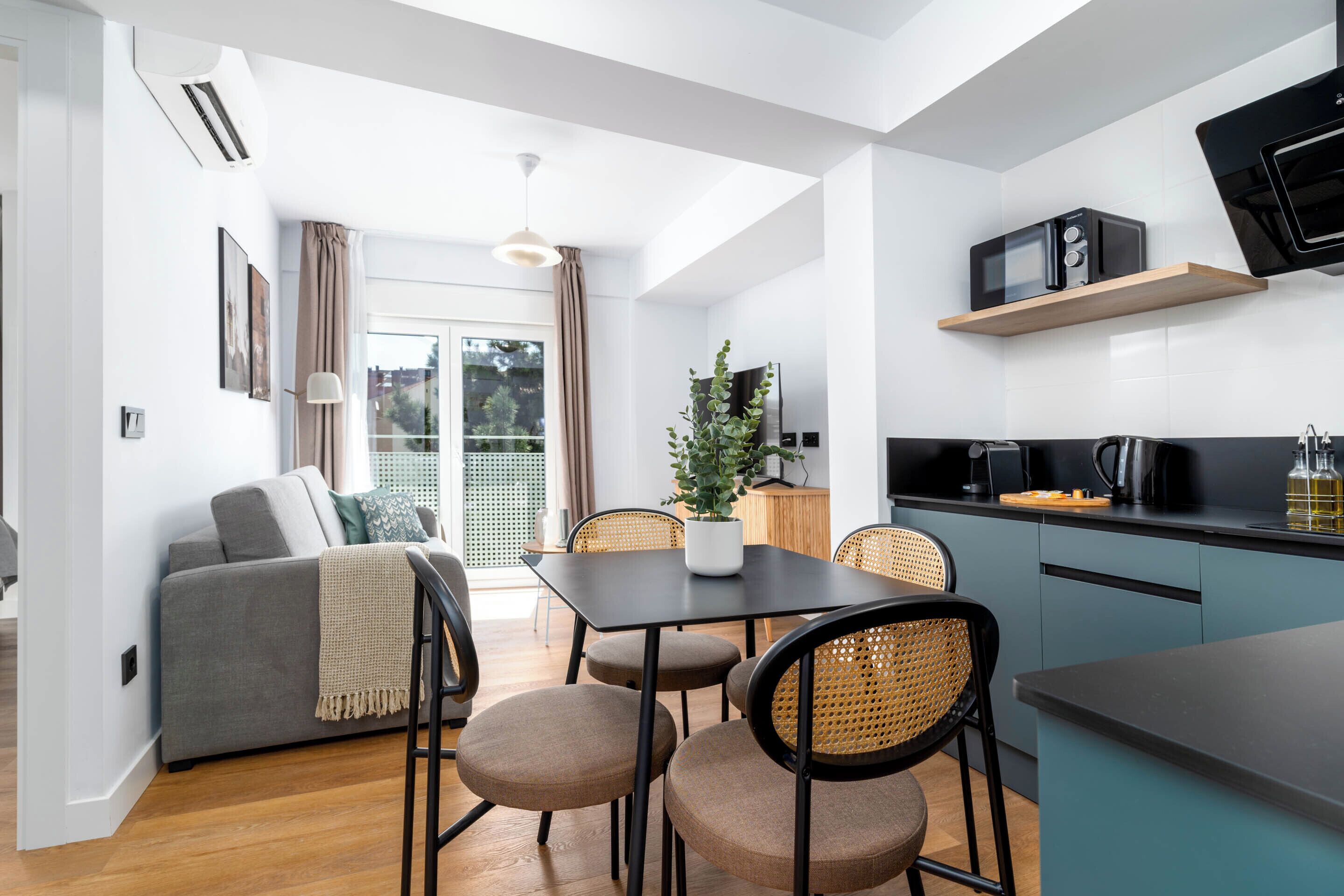One-Bedroom Junior Apartment + Balcony | Living area | 50-inch flat-screen TV with cable channels