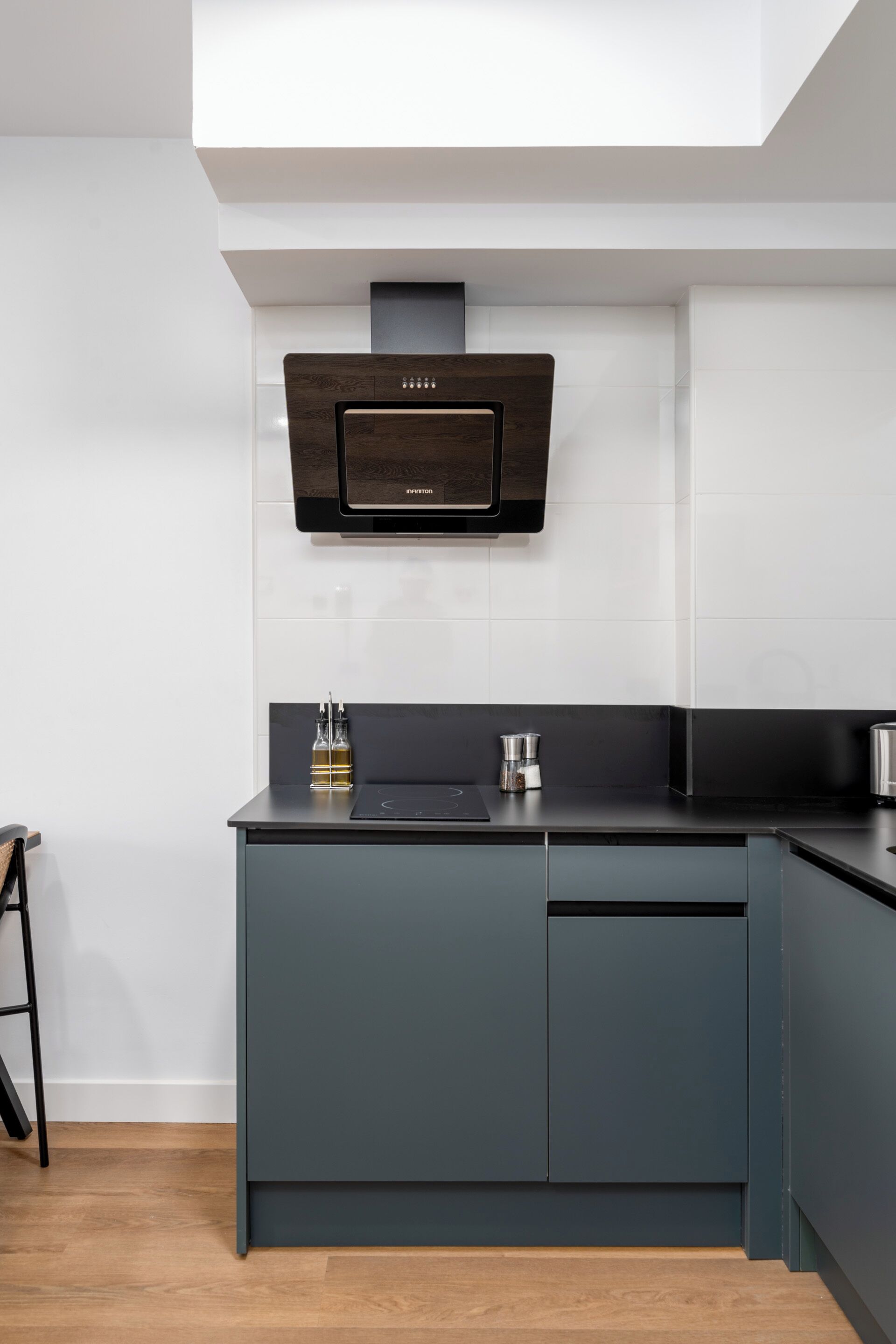 A modern kitchen with a built-in microwave, a coffee maker, and a cabinet.