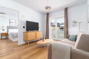 One-Bedroom Family Apartment + Balcony | Living area | 50-inch flat-screen TV with cable channels