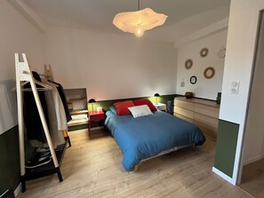 Cozy bedroom with a single bed, wardrobe, and bedside table.