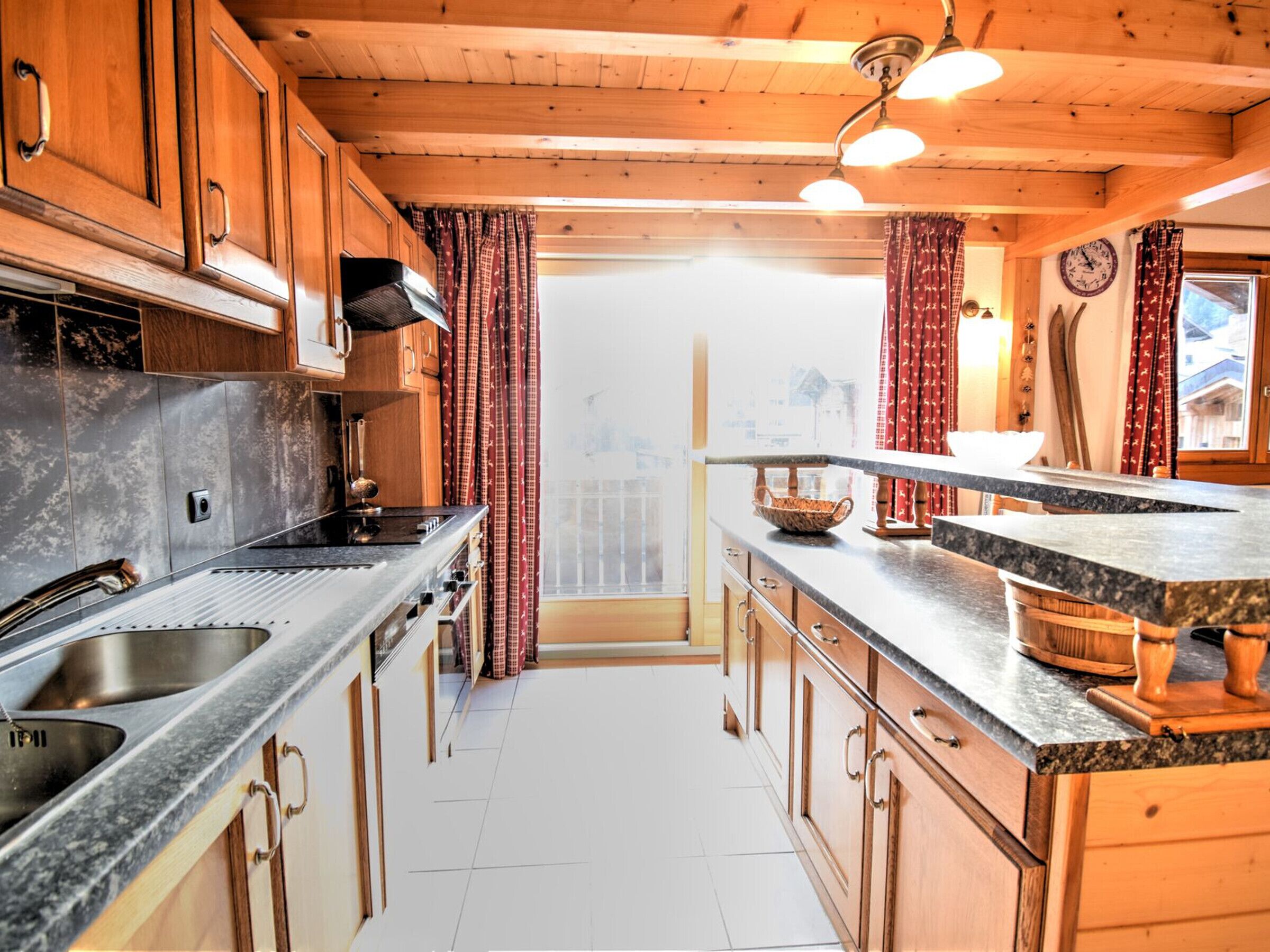 A modern kitchen with wooden cabinets, granite countertops, and a central island.