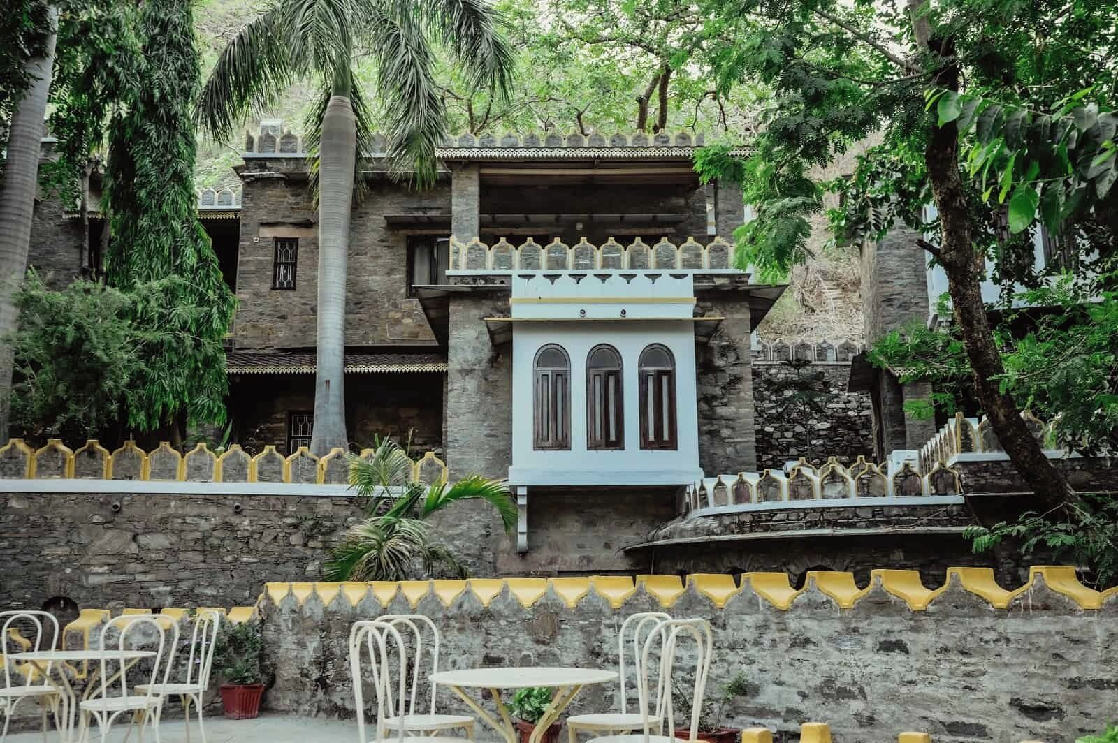 A traditional building with a stone facade, arched windows, and a decorative railing.