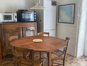 Enjoy meals in this cozy kitchen with a table for four, refrigerator, microwave, and toaster oven.