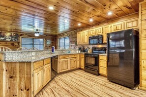 Enjoy cooking in this well-equipped kitchen with a refrigerator, oven, and microwave.
