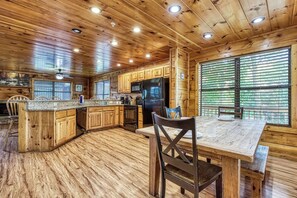 Enjoy meals in the kitchen with a central island, dining table, and microwave.
