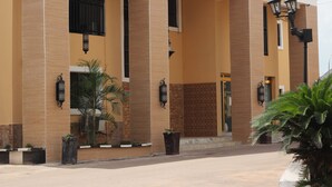 A building with a beige facade, large columns, and multiple windows.