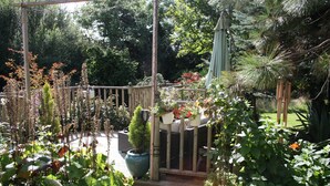A garden with various potted plants and a wooden fence.
