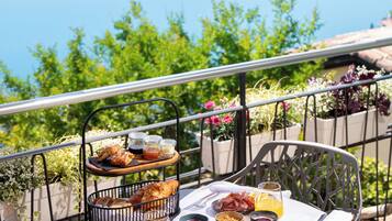 A table set with breakfast items overlooking a lake.
