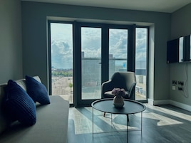 Elite Apartment | Living area | 40-inch flat-screen TV with cable channels