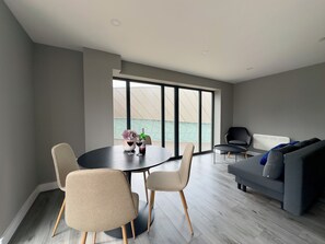 Deluxe Apartment | Living area | 40-inch flat-screen TV with cable channels
