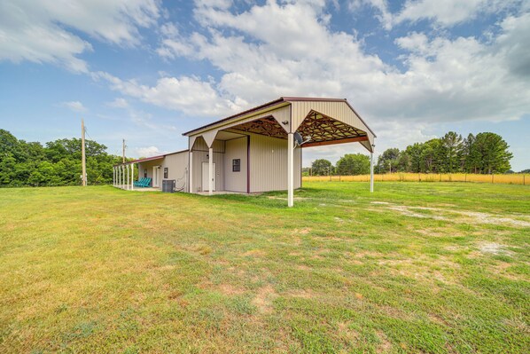 A single-story building with a covered porch and a small attached structure.