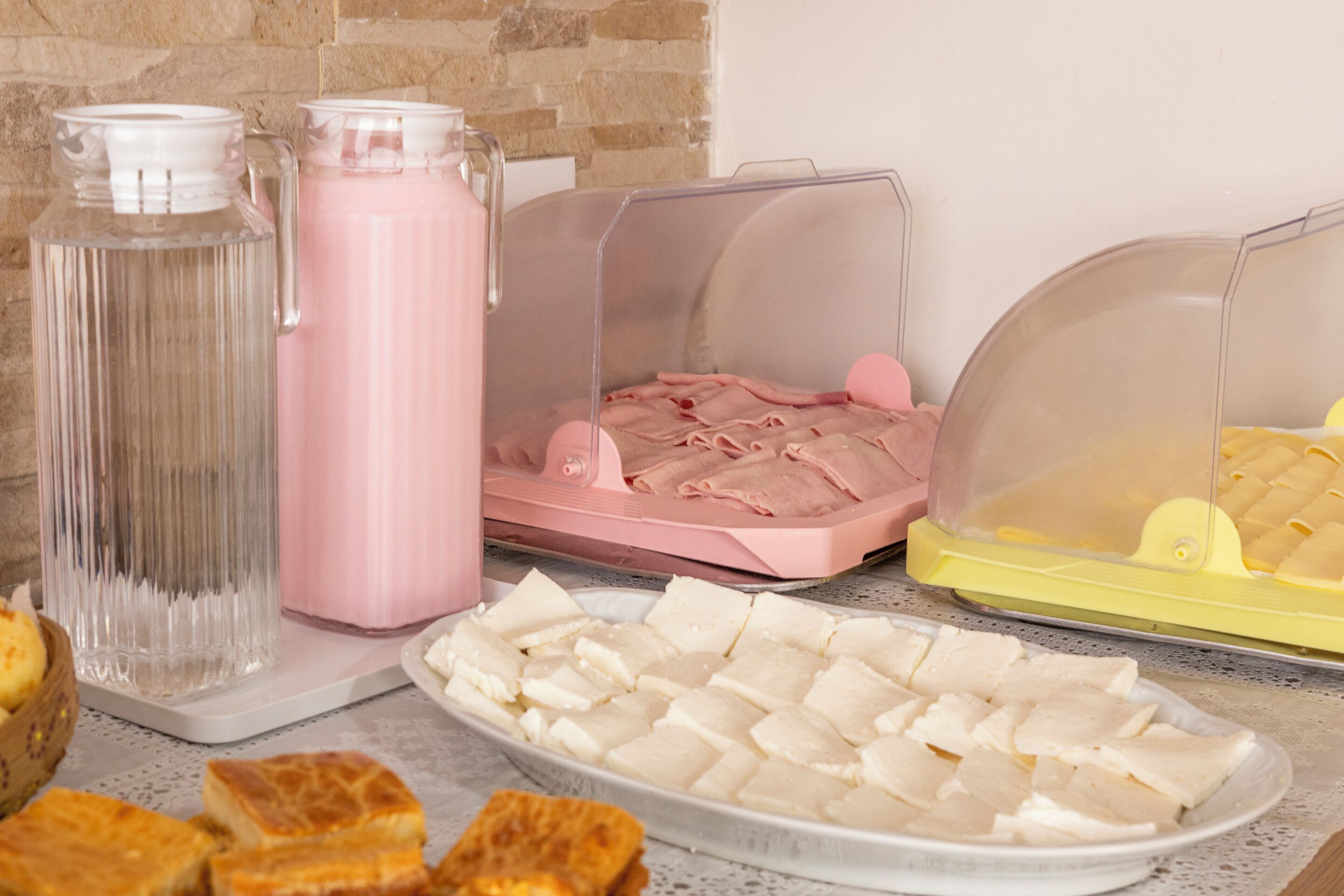 A buffet setup with various food items and drink dispensers.