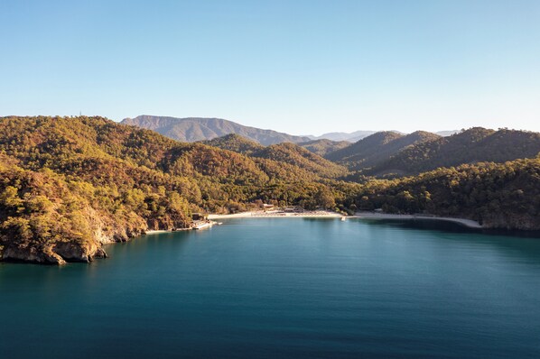 A coastal landscape with a bay, forested hills, and distant mountains. - Ahama - Relais & Châteaux (Fethiye)