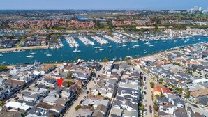 A marina with numerous boats docked, surrounded by residential buildings.