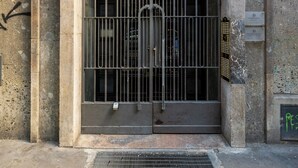 A large, barred entrance with a sign above reading "INA". - Gramsci 3 Studios by Wonderful Italy (Bologna)