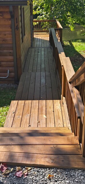 A wooden deck leading to a building with a number '4' on the side. - Cozy cabin in Brasher Falls, NY (Brasher Falls)