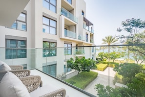 A modern apartment building with multiple balconies, glass railings, and a well-maintained garden area. - Waterfront 2BR Apartment in The Address Fujairah Residences Block C, Fujairah (Fujairah)