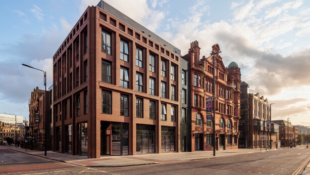 A modern building with large windows and a brick facade.