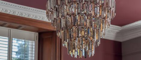 A chandelier with multiple crystal elements hanging from the ceiling.