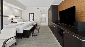 A modern hotel room with a large bed, a TV, a desk, and a wardrobe. - Pool, Spa, Dining, Parking – Resort Style Studio (Miami)