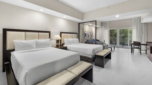 A hotel room with two beds, a desk, a chair, a bench, and a balcony with a view. - Heart of Downtown Doral – Resort Style Studio (Miami)