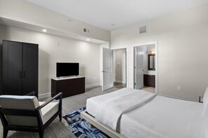 A hotel room with a bed, a TV on a dresser, a wardrobe, and a bathroom visible through an open door. - 3 Bedroom Villa, 4 bathrooms, sleep 8, Resort Pool (Miami)