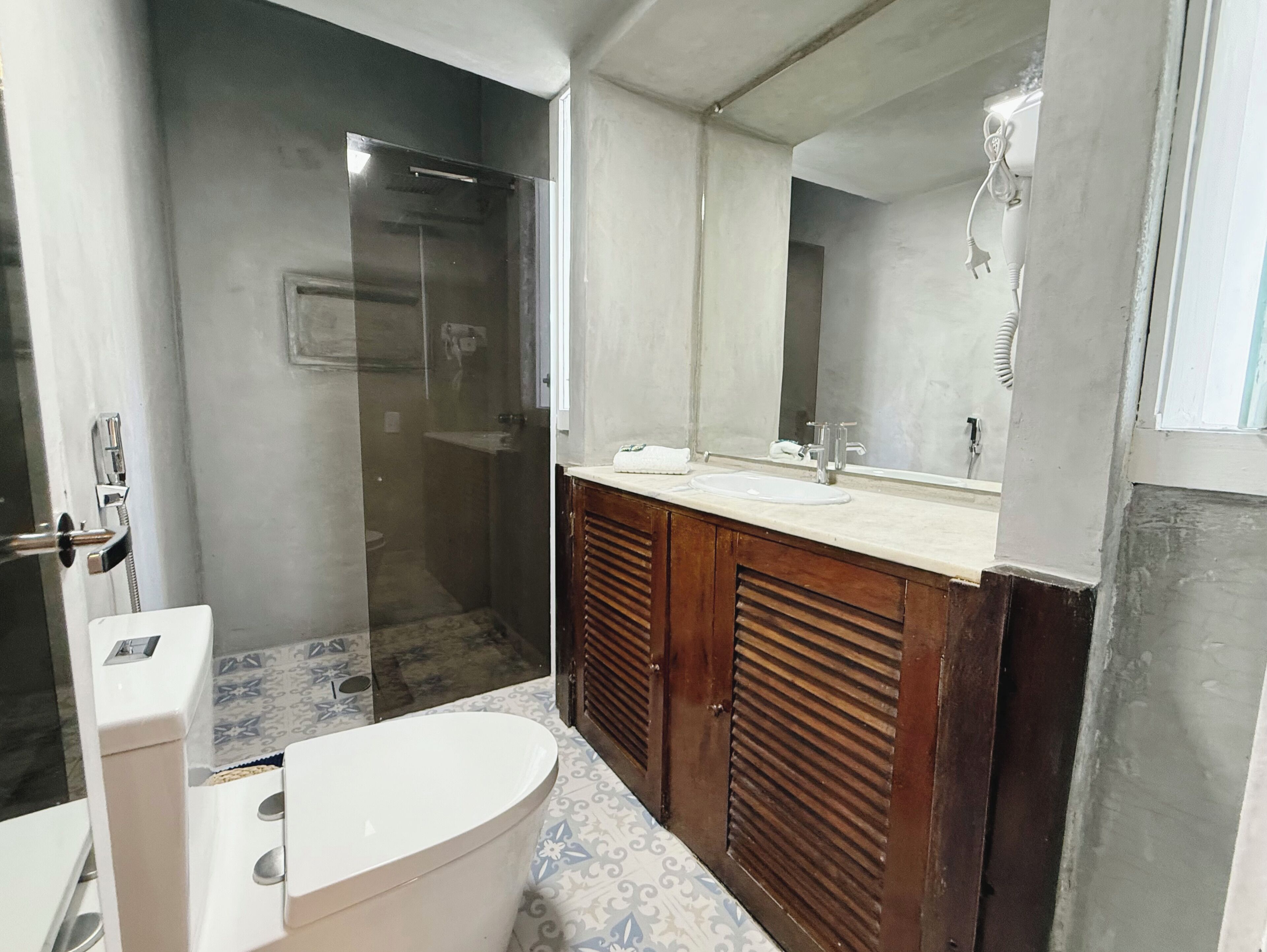 A bathroom with a shower, toilet, and sink.