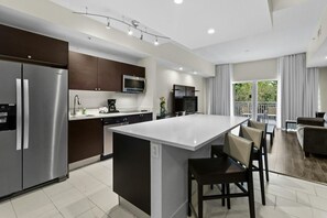A modern kitchen with a central island, built-in appliances, and a dining area with a view. - 3 Bed/4 Bath TONS of Space, Pool, Dining, Bar, Spa (Miami)