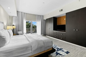 A modern hotel room with a large bed, a TV, a wardrobe, and a balcony with curtains. - 3 Bed/4 Bath TONS of Space, Pool, Dining, Bar, Spa (Miami)