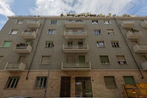 A multi-story building with balconies, windows, and a door. - Casa Gabri by Wonderful Italy (Turin)
