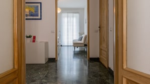 A hallway leading to a room with a chair and a desk. - Casa Gabri by Wonderful Italy (Turin)