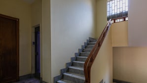 A staircase with marble steps and wooden handrails, leading to a landing with a door. - Casa Gabri by Wonderful Italy (Turin)
