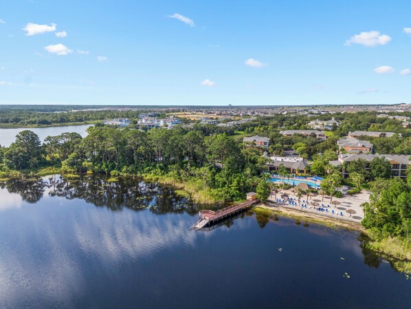A lakeside resort with a dock, pool area, and multiple buildings. - Family Fun Awaits! 10% OFF 7Night Stay Resort Access + Patio & 15min to Disney (Davenport)