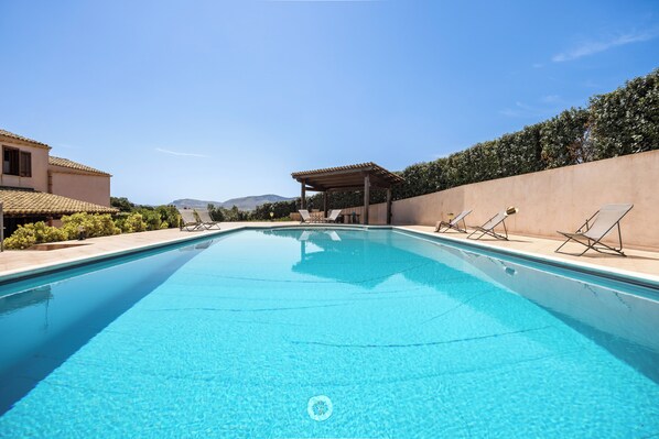 Seasonal outdoor pool, pool loungers