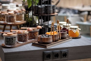 A buffet setup with various food items and utensils.