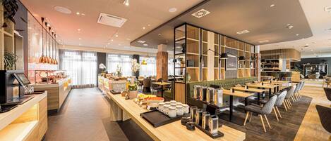 A modern cafe with a long counter, seating area, and wooden accents.