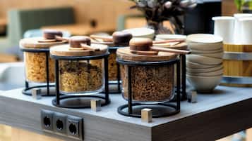 A kitchen counter with three glass jars with wooden lids, a coffee maker, and stacked bowls.