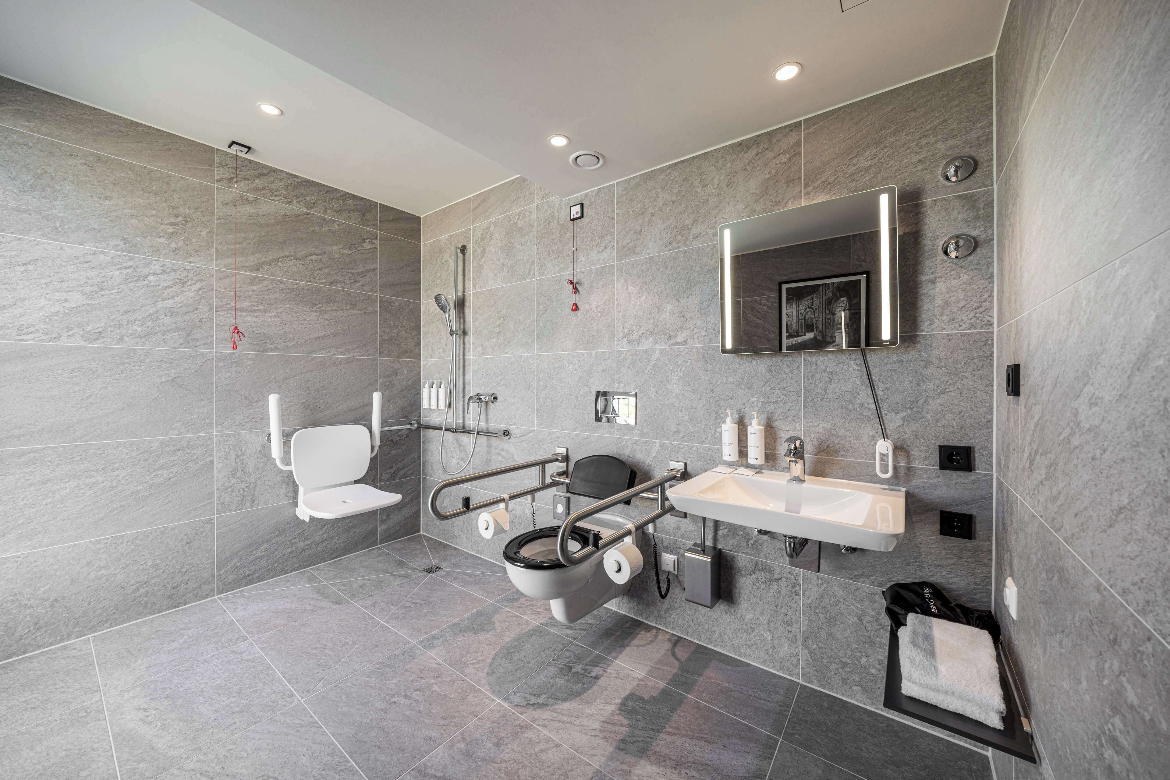 A modern bathroom with a toilet, bidet, and shower.
