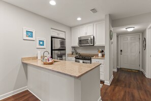 Fridge, microwave, oven, stovetop - Beachfront Top Floor Condo | Pool | Elevator | Balcony | Beach Gear | Ground-Level Storage (St. Simons Island)