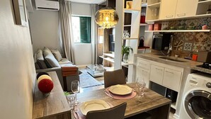 Ein kompakter Wohnraum mit Essbereich, Küche und Wohnzimmer.
