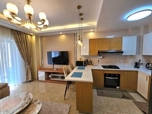 Fridge, microwave, cookware/dishes/utensils, dining tables - Lux Suites Enzi Heights Apartments (Nairobi)