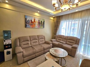Comfort Apartment, City View | Living area | 24-inch Smart TV with digital channels - Lux Suites Enzi Heights Apartments (Nairobi)