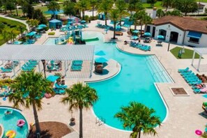 A resort pool area with multiple swimming pools, lounge chairs, and palm trees. - Free Water Park Private Pool and Lakeview (Kissimmee)