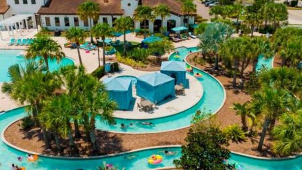 A resort with a large pool area, multiple water slides, and lounge chairs. - Free Water Park Private Pool and Lakeview (Kissimmee)