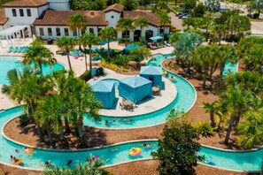 A resort with a large pool area, multiple water slides, and lounge chairs. - Free Water Park Private Pool and Lakeview (Kissimmee)