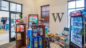 A hotel lobby with a vending machine, snack display, and a large 'W' sign on the wall. - Free Water Park Private Pool and Lakeview (Kissimmee)