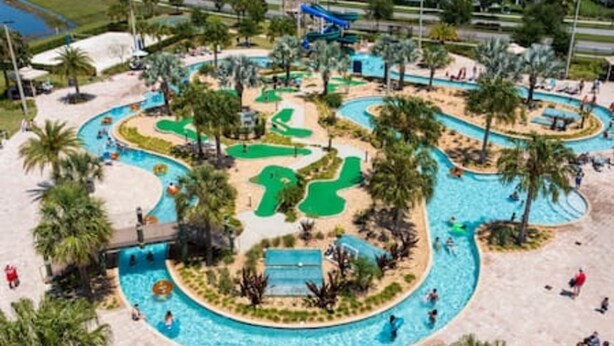 A water park with multiple pools, slides, and a winding path. - Gorgeous Home With Pool and Lake View (Kissimmee)